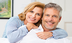 middle age couple smiling and at ease with their estate planning services
